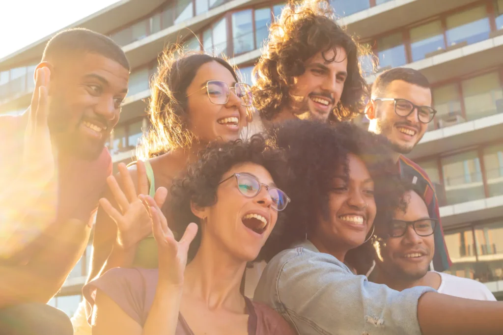 Joyful multiethnic friends taking funny group selfie (1)