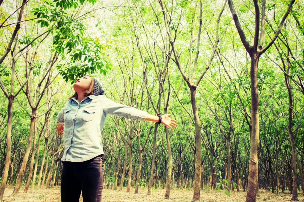 Teenager with open arms nature