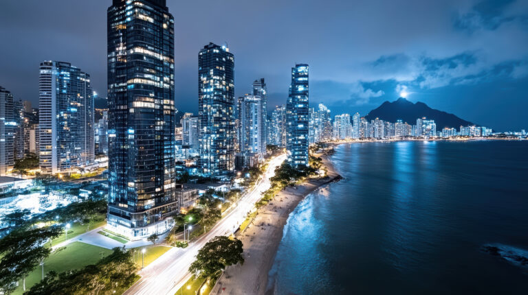 Stunning cityscape at night featuring modern skyscrapers and serene beach