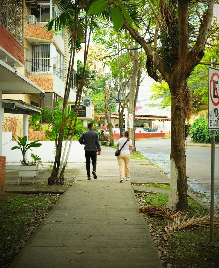 People walking on tree lined street in El Cangrejo Panama City